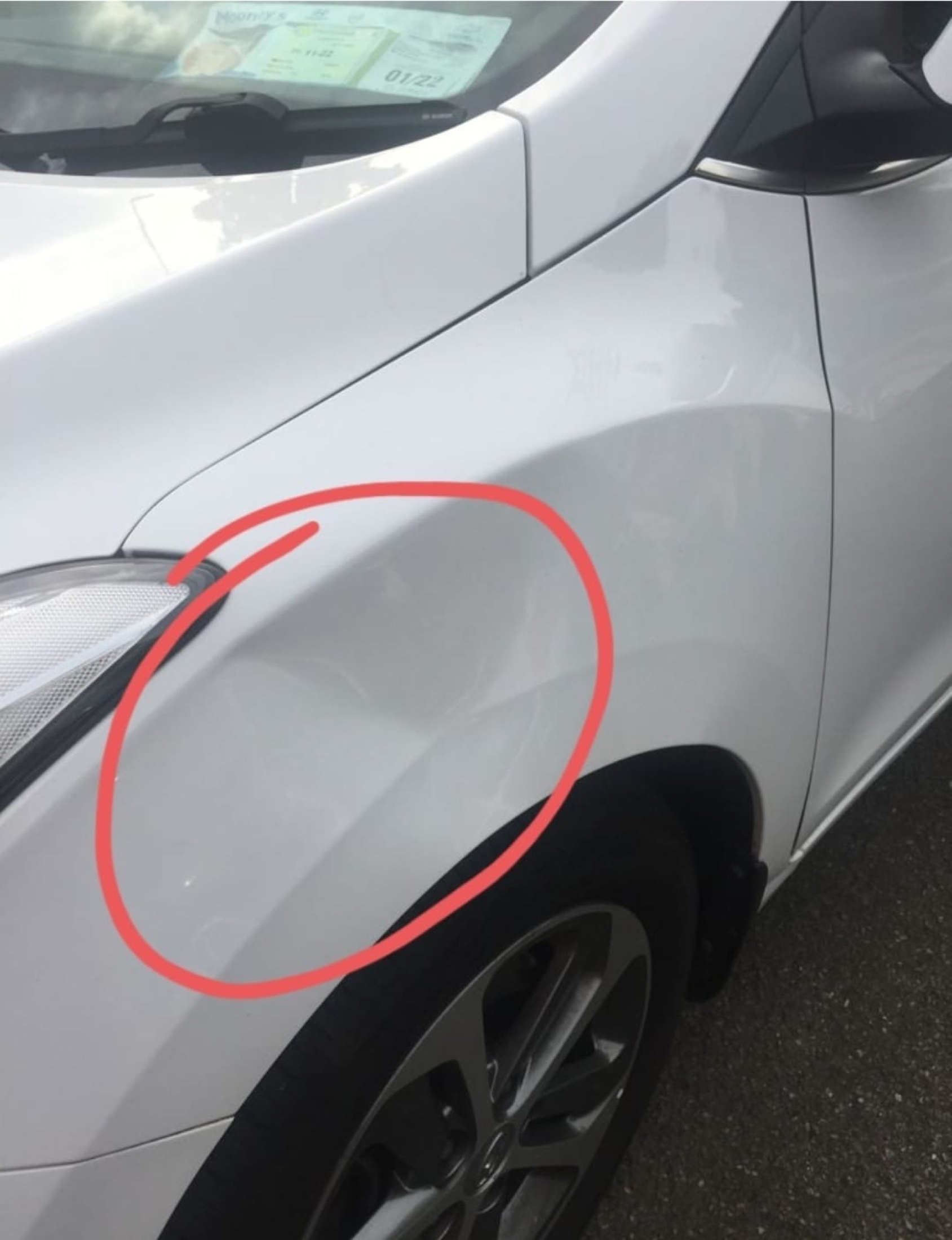 Front wing dent before paintless dent repair